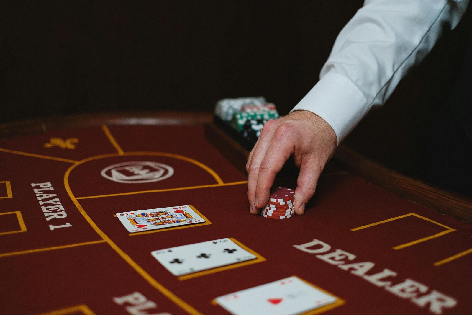 Hand moving chips on blackjack table layout