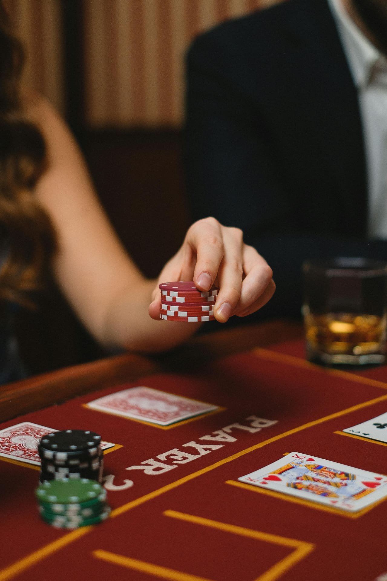 Guest stacking pink chips on casino table