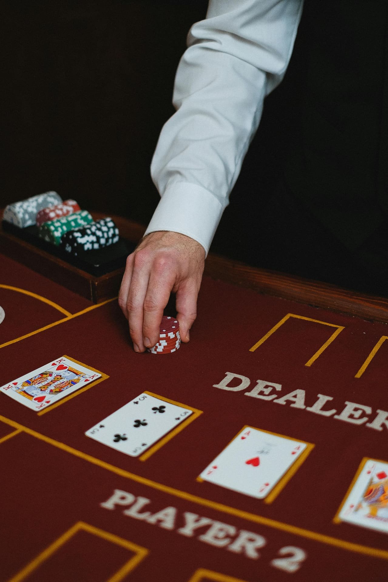 Dealer placing chips near player cards